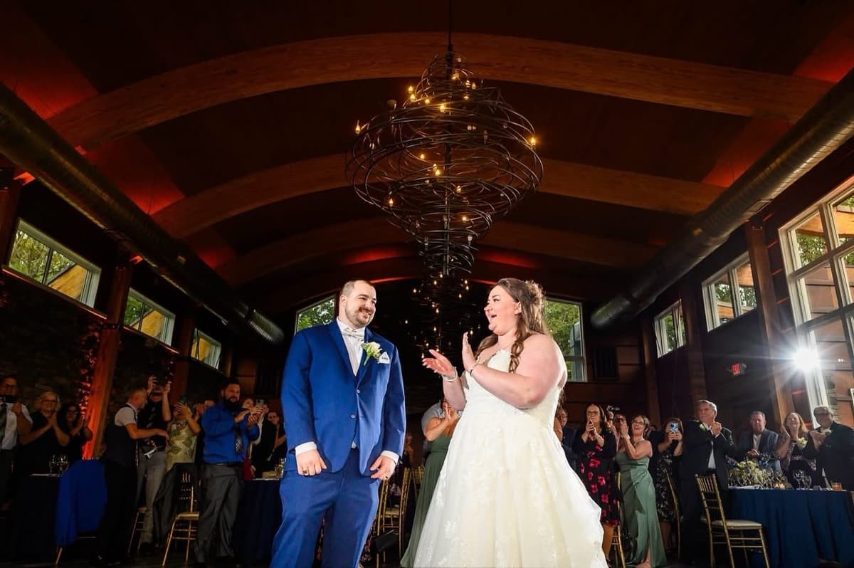 Couple making their grand entrance to applause from wedding guests