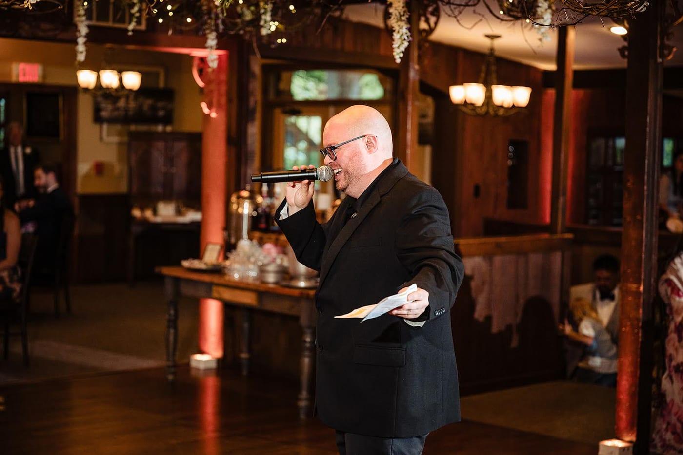 Anthony DeStefano hosting with microphone at a wedding reception