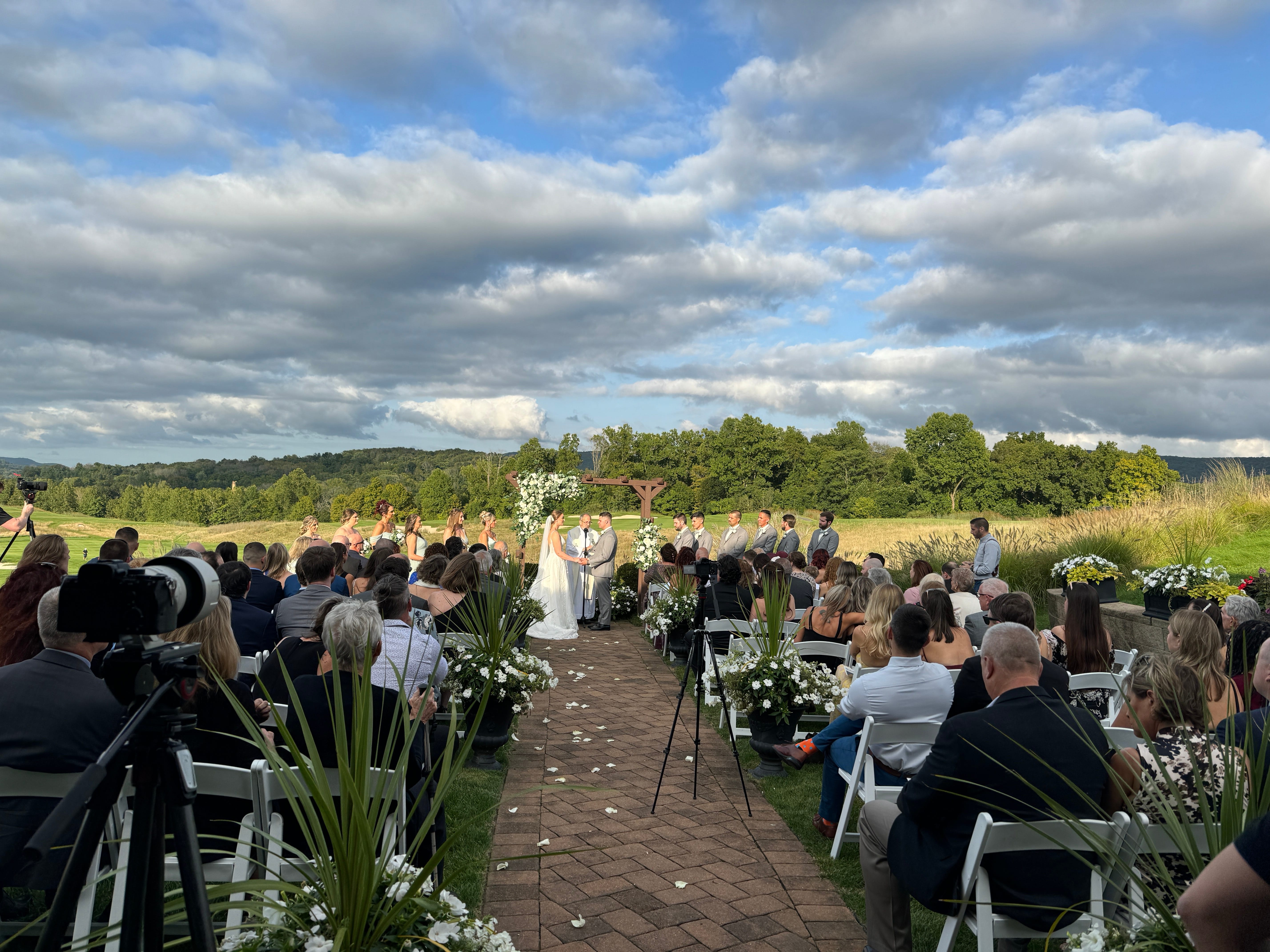Outdoor wedding ceremony at Ballyowen with couples walking down the aisle