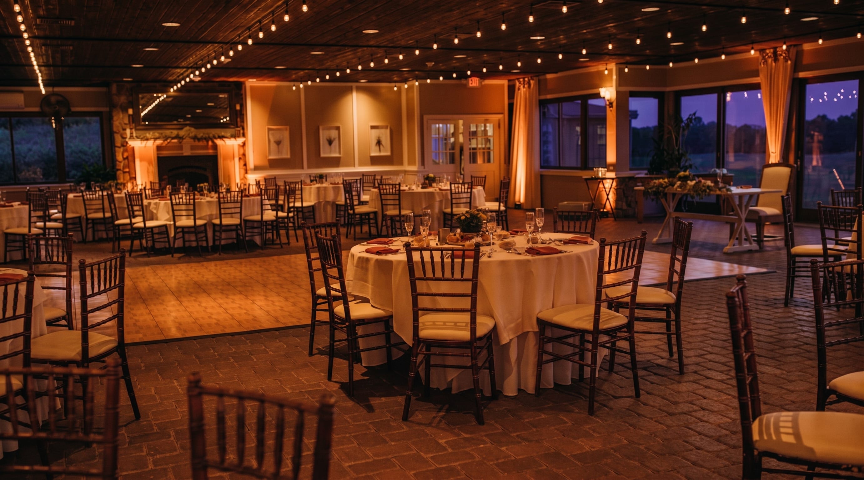 Ballyowen Golf Club reception room illuminated with warm uplighting during a wedding reception