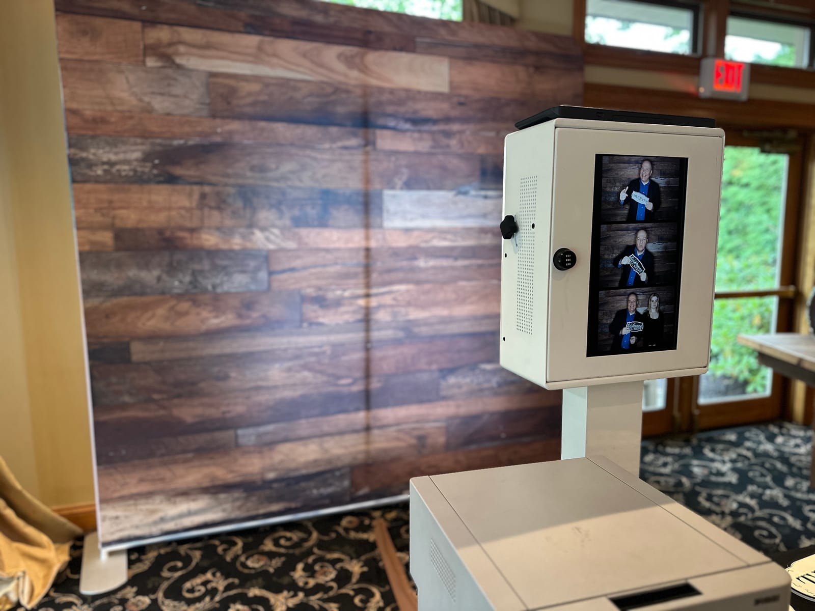 Guests at the photo booth with a rustic wood backdrop at a Black Bear Golf Club wedding