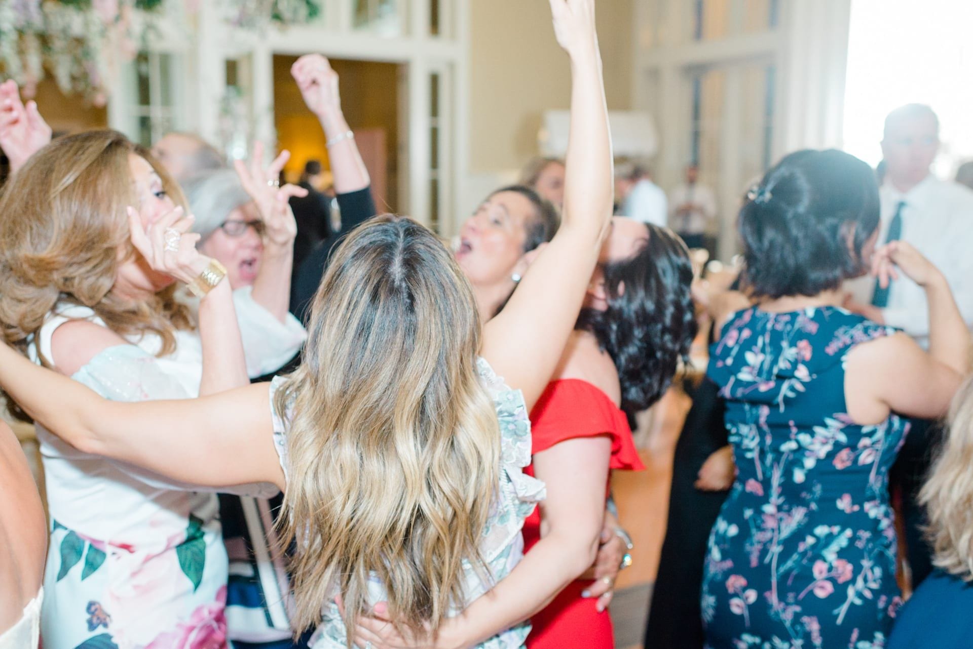 Guests dancing with arms raised at The Ryland Inn wedding reception