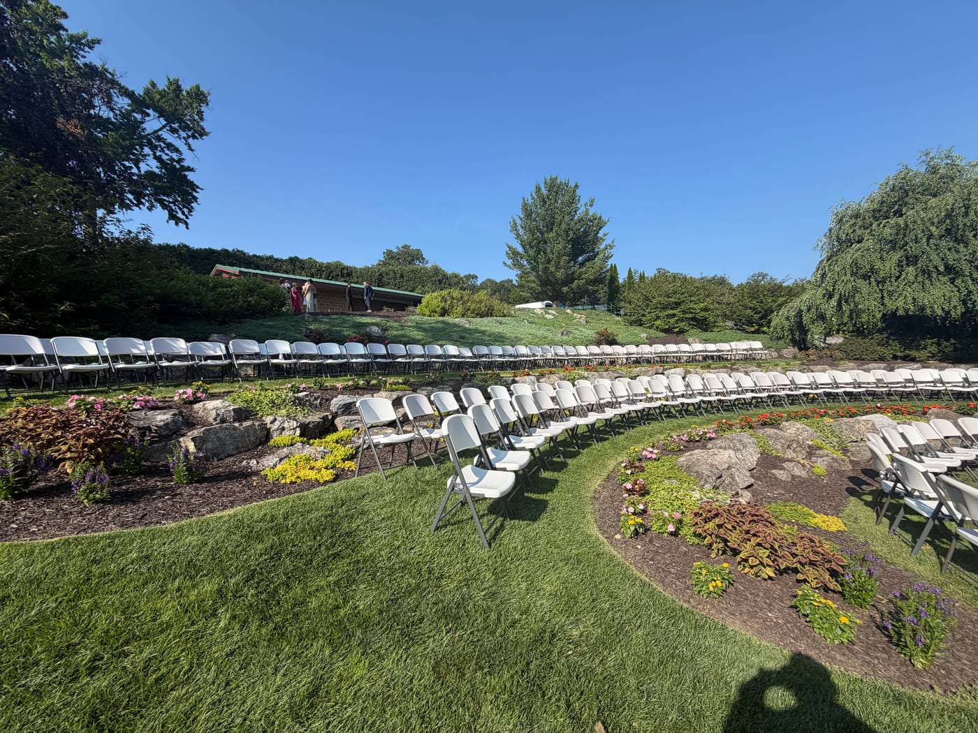Garden amphitheater ceremony seating among boulders and flower beds at WoodStone Country Club