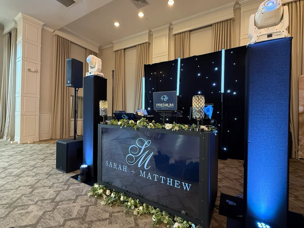 Personalized DJ booth with blue-lit columns and a starry backdrop at Grand Cascades Lodge