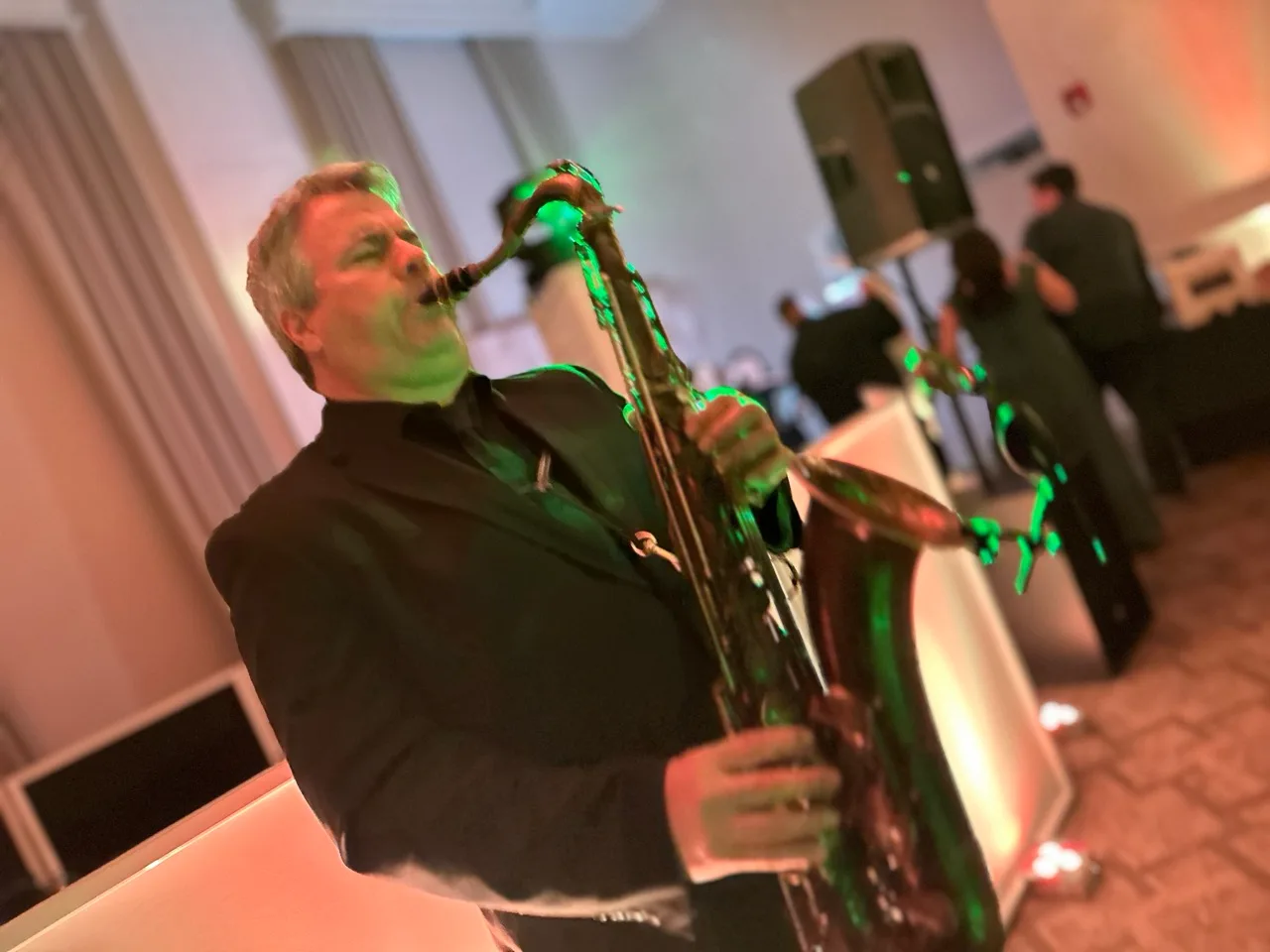 Live saxophonist performing on the wedding dance floor at Grand Cascades Lodge