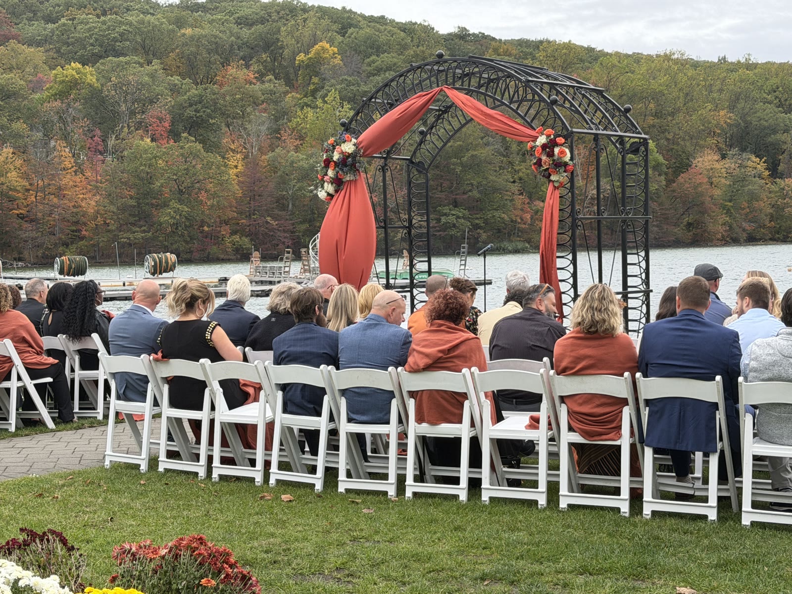 Guests seated for a waterfront wedding ceremony at Lake Valhalla Club overlooking the lake and forested ridge