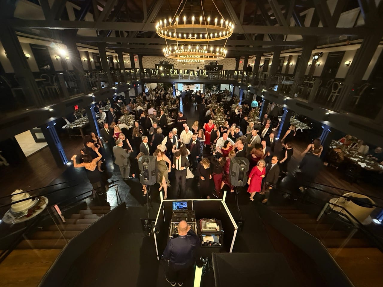 Packed Park Loft wedding dance floor viewed from behind the DJ setup