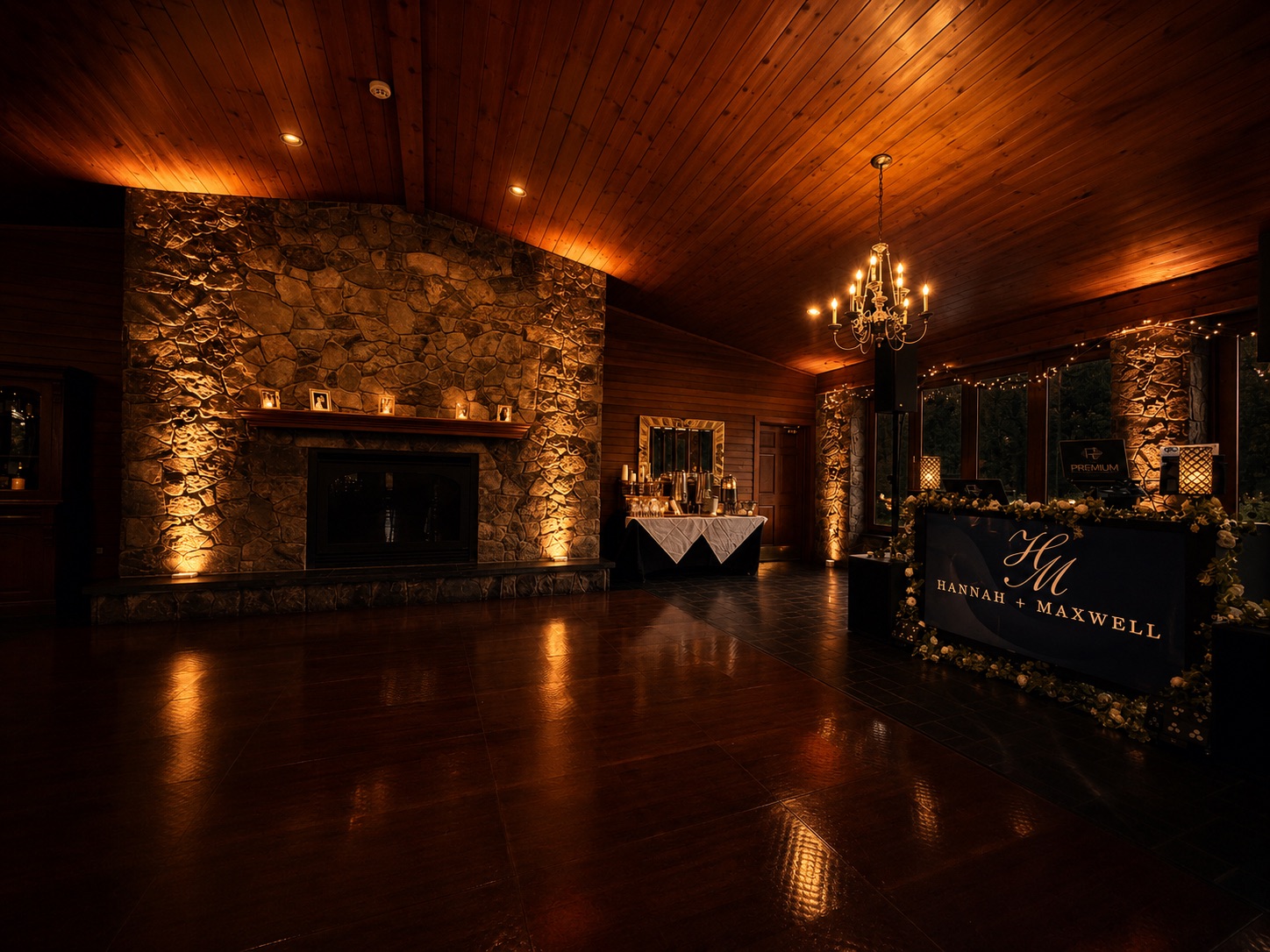 Lawnhaven at Stroudsmoor by Wedgewood Weddings — amber uplighting on stone fireplace and DJ Anthony's booth with the H+M monogram
