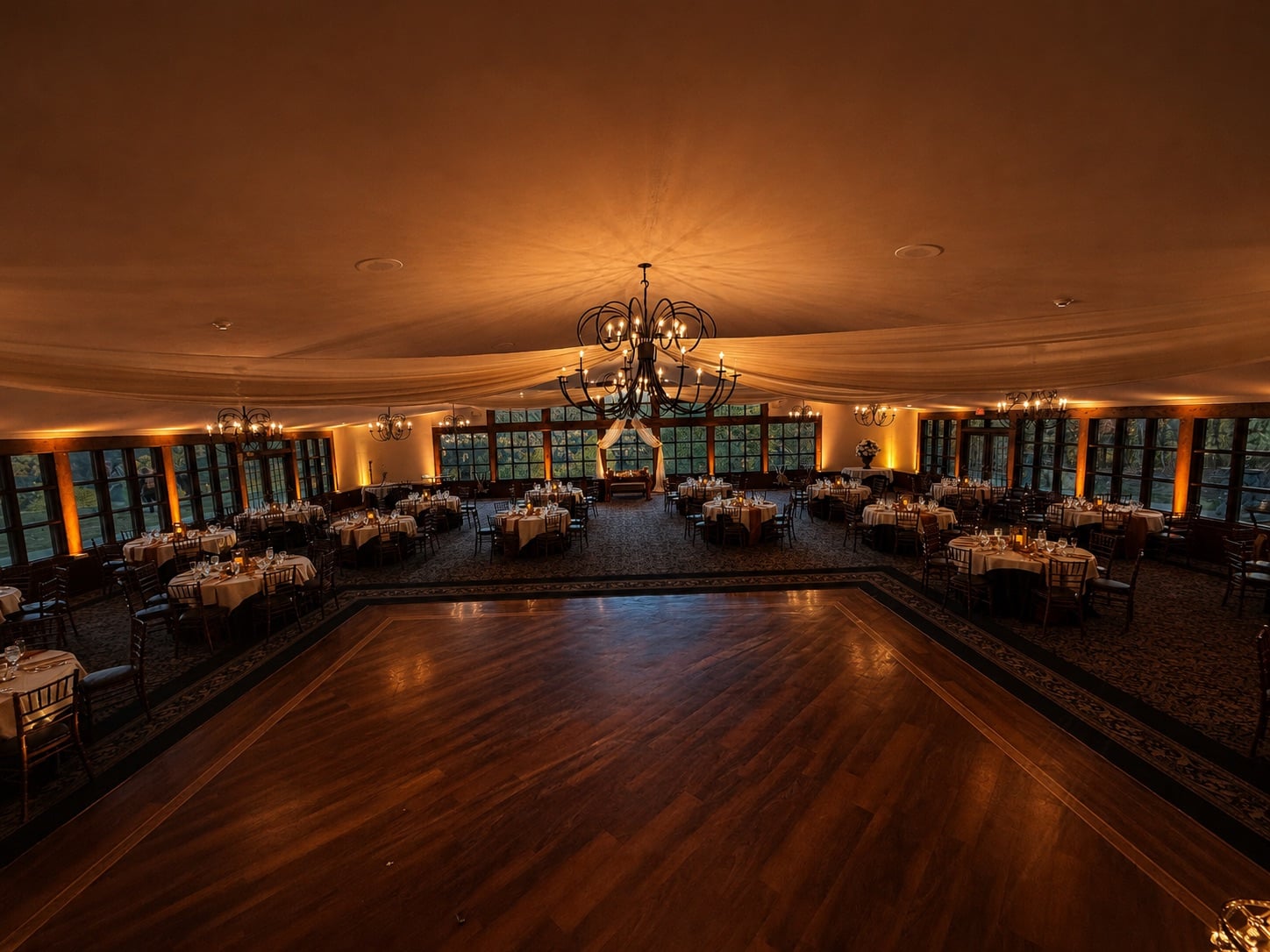 Ridgecrest at Stroudsmoor by Wedgewood Weddings with Premium Entertainment amber uplighting washing the walls beneath the draped ceiling