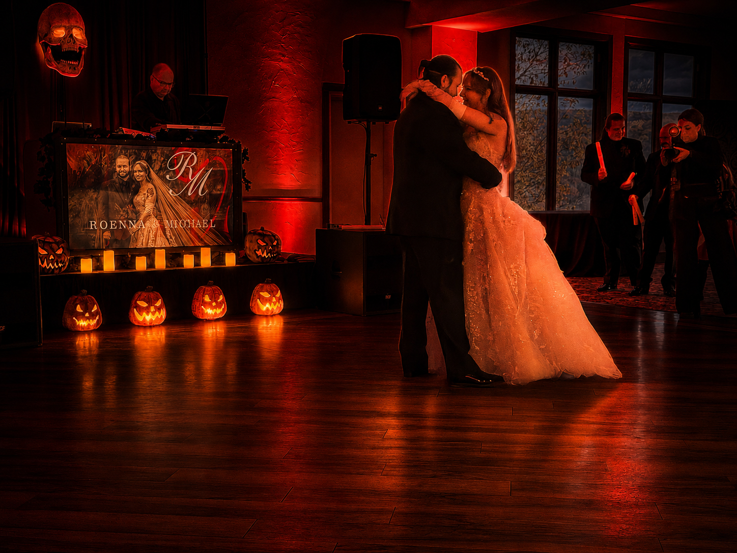 Custom Halloween wedding at Terraview — DJ booth décor with jack-o'-lanterns and personalized monogram backdrop